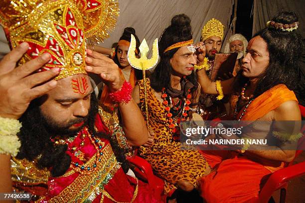 Indian artists dressed as Hindu Lord Shiv , Lord Rama and the demon Ravana put on their make-up before performing the Ramleela, the story of Lord...