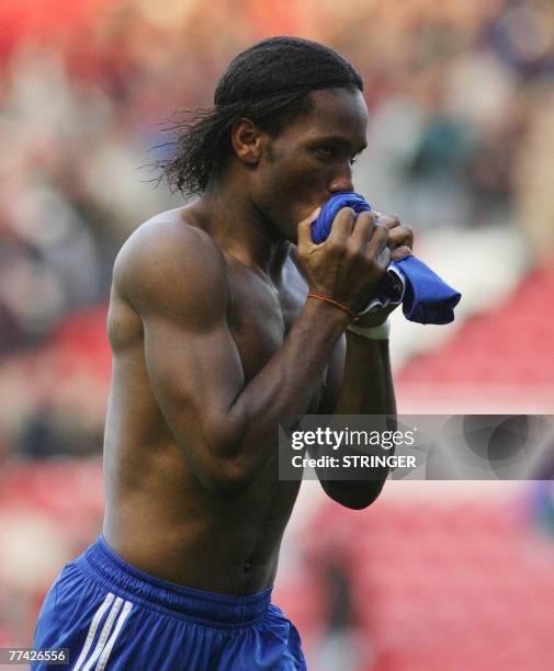 Chelsea's Didier Drogba kisses his Chelsea shirt before throwing it to his fans after a Premiership football match against Middlesbrough at the...