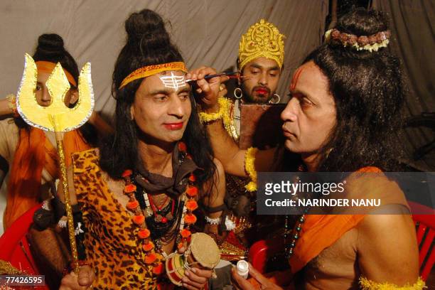 Indian artists dressed as Hindu Lord Shiva and Lord Rama put on their make-up before performing the Ramleela, the story of Lord Rama, in Amritsar, 20...