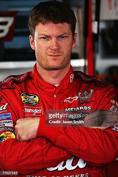 Dale Earnhardt Jr., driver of the Budweiser Chevrolet, stands in the garage area, during practice for the NASCAR Nextel Cup Series Subway 500 at...