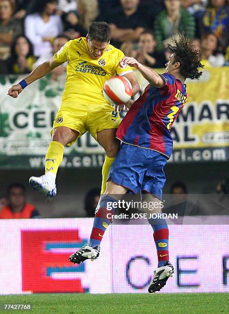 Villarreal's Mexican Guille Franco vies for the ball with Barcelona's Argentinian Gabriel Milito during their Spanish league football match at...