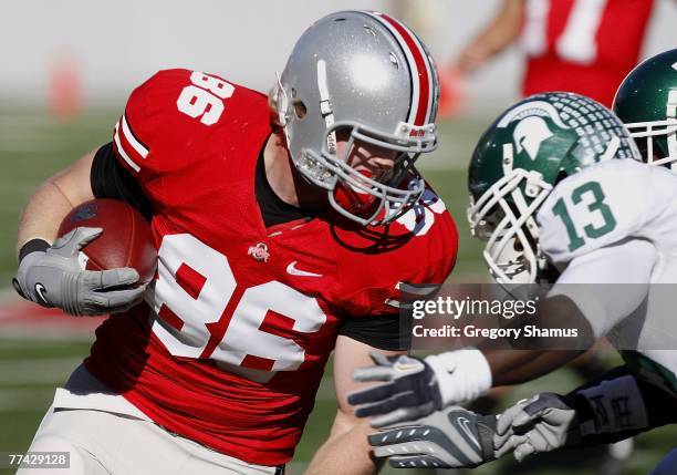 Jake Ballard of the Ohio State Buckeyes tries to avoid the tackle of Travis Key of the Michigan State Spartans during first quarter action on October...