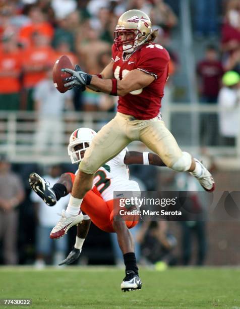 Defensive back Anthony Houllis of the Florida State Seminoles intercepts a pass in front of receiver Sam Shields of the University of Miami...