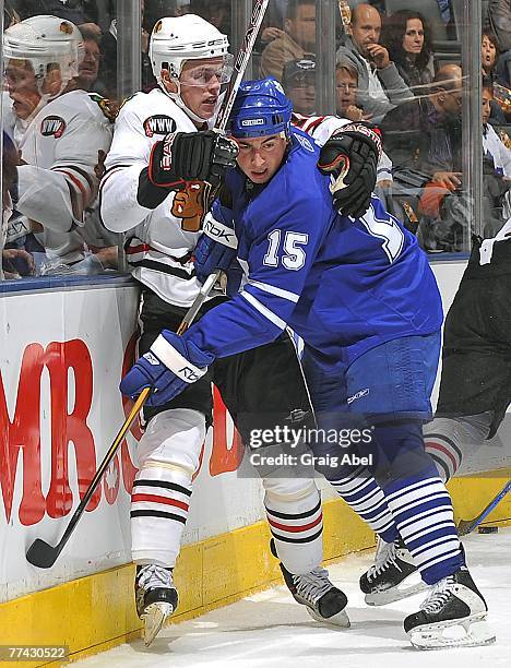Tomas Kaberle of the Toronto Maple Leafs battles for position with Jonathan Toews of the Chicago Blackhawks October 20, 2007 at the Air Canada Centre...