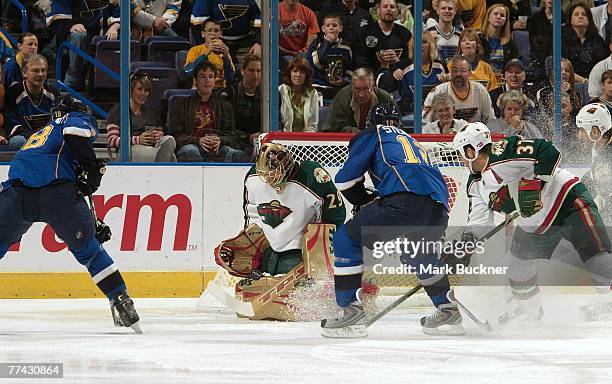 Josh Harding of the Minnesota Wild makes a save on Jay McClement of the St. Louis Blues on October 20, 2007 at Scottrade Center in St. Louis,...