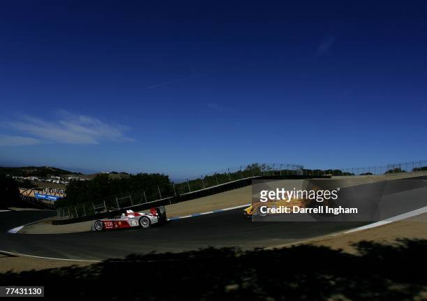 Allan McNish drives the Audi Sport North America Audi R10 TDI ahead of Timo Bernhard driving the Penske Racing Porsche RS Spyder during the American...