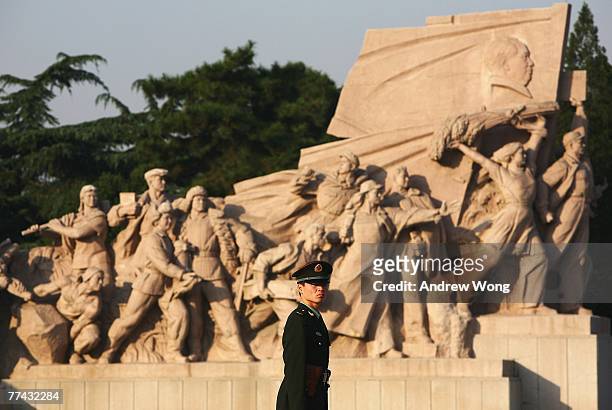 Chinese policeman stands guard outside the Mao Zedong Mausoleum, which commemorates the late founder of the People's Republic of China, before the...