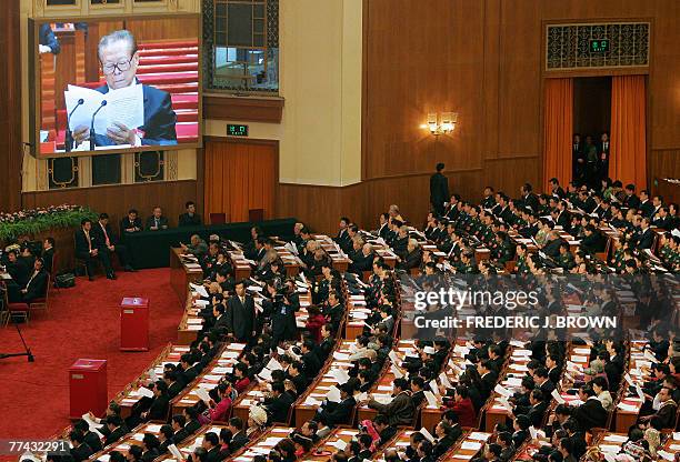 Former Chinese President Jiang Zemin is seen live on a big screen at the closing session of the ruling Communist's 17th five-yearly Party Congress,...