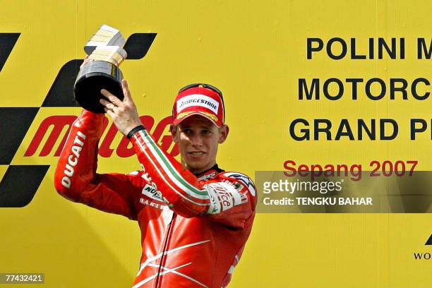 Australian rider Casey Stoner of Ducati celebrates after winning the Malaysian Motorcycle Grand Prix at the Sepang International Racing Circuit in...