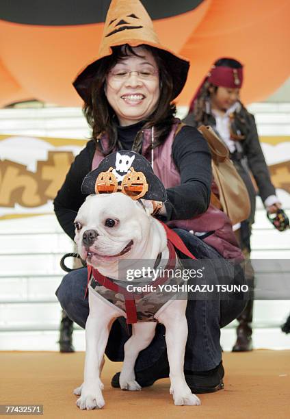 Japanese woman displays her costumed dog during an annual contest for Holloween, in Kawasaki, Kanagawa prefecture, 21 October 2007. Some 30 owners...