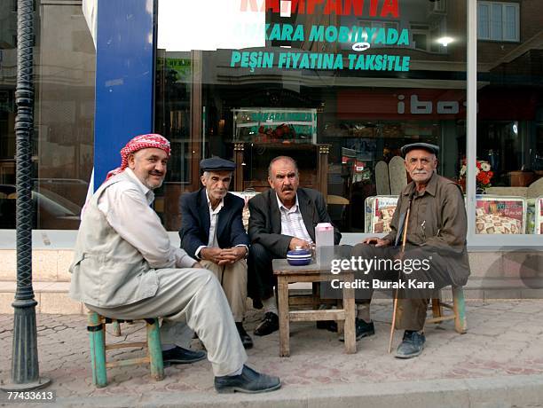 Kurdish men sit out on the street together on October 21, 2007 in the Iraqi border Turkish town of Cizre, Turkey. Kurds in the southeastern Turkish...