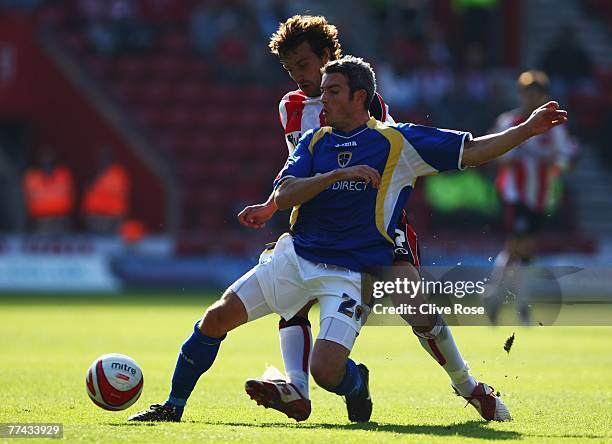 Kevin McNaughton of Cardiff City is challenged by Inigo Idiakez of Southampton during the Coca-Cola Championship match between Southampton and...