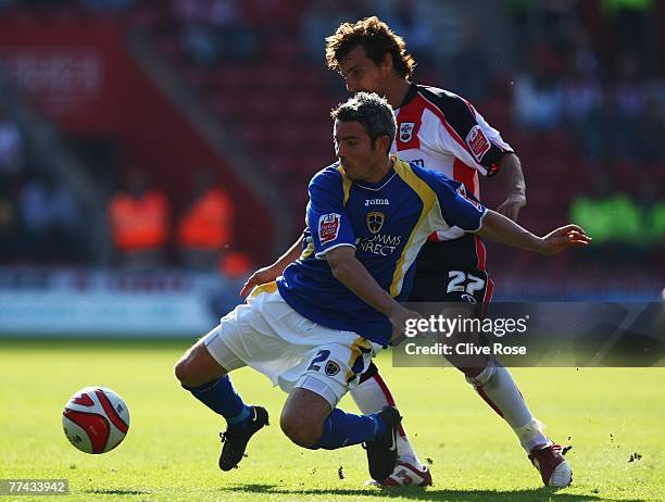 Kevin McNaughton of Cardiff City is challenged by Inigo Idiakez of Southampton during the Coca-Cola Championship match between Southampton and...