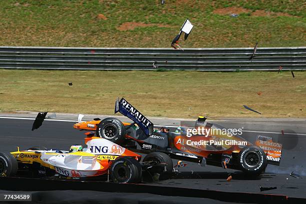Sakon Yamamoto of Japan and Spyker F1 runs into the back of Giancarlo Fisichella of Italy and Renault at the start of the Brazilian Formula One Grand...