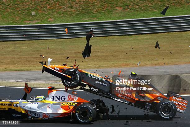 Sakon Yamamoto of Japan and Spyker F1 runs into the back of Giancarlo Fisichella of Italy and Renault at the start of the Brazilian Formula One Grand...