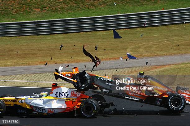 Sakon Yamamoto of Japan and Spyker F1 runs into the back of Giancarlo Fisichella of Italy and Renault at the start of the Brazilian Formula One Grand...