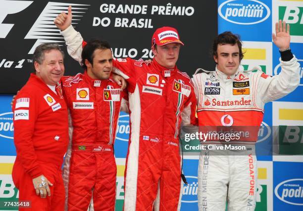 Ferrari Team Principal Jean Todt, second placed Felipe Massa of Brazil and Ferrari, race winner and new F1 World Champion Kimi Raikkonen of Finland...