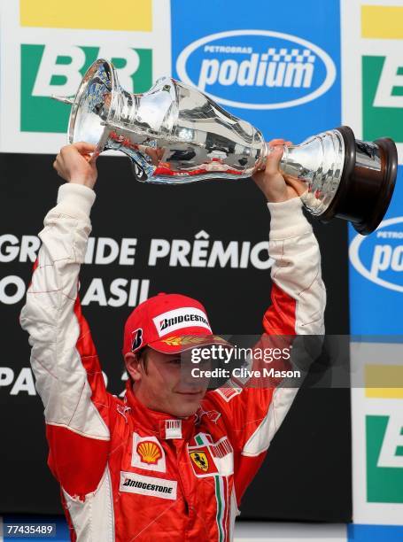 Kimi Raikkonen of Finland and Ferrari celebrates on the podium after winning the race and the F1 World Championship at the Brazilian Formula One...