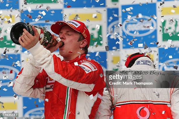 Race winner and new F1 World Champion Kimi Raikkonen of Finland and Ferrari and last years champion third placed Fernando Alonso of Spain and McLaren...