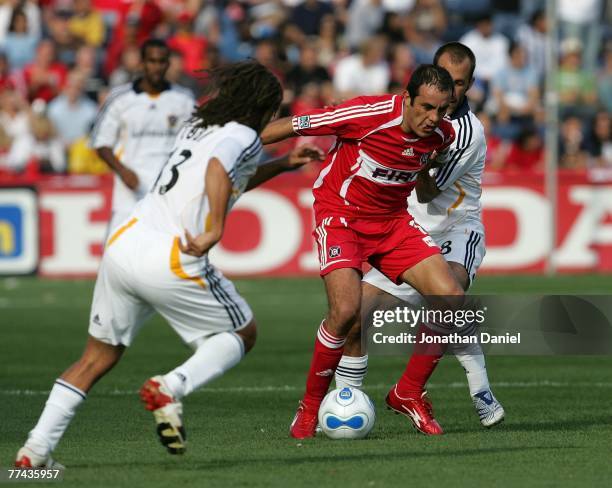 Cuauhtemoc Blanco of the Chicago Fire splits defenders Cobi Jones and Peter Vagenas of the Los Angeles Galaxy on October 21, 2007 at Toyota Park in...