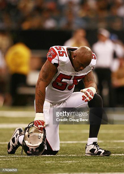 Defensive end John Abraham of the Atlanta Falcons takes hangs his head during a stoppage in play while taking on the New Orleans Saints at the...