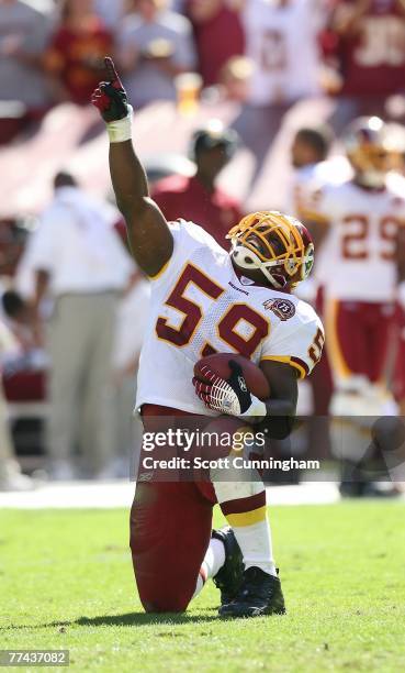 London Fletcher of the Washington Redskins celebrates after returning an interception for a touchdown against the Arizona Cardinals at FedEx Field...