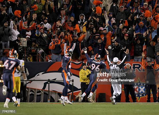 Tim Crowder of the Denver Broncos scores a second quarter touchdown on a 50 yard return of a fumble by Ben Roethlisberger of the Pittsburgh Steelers...