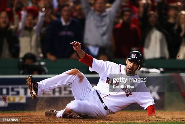 Mike Lowell of the Boston Red Sox slides into home plate safe on a hit by J.D. Drew in the eighth inning against Cleveland Indians during Game Seven...