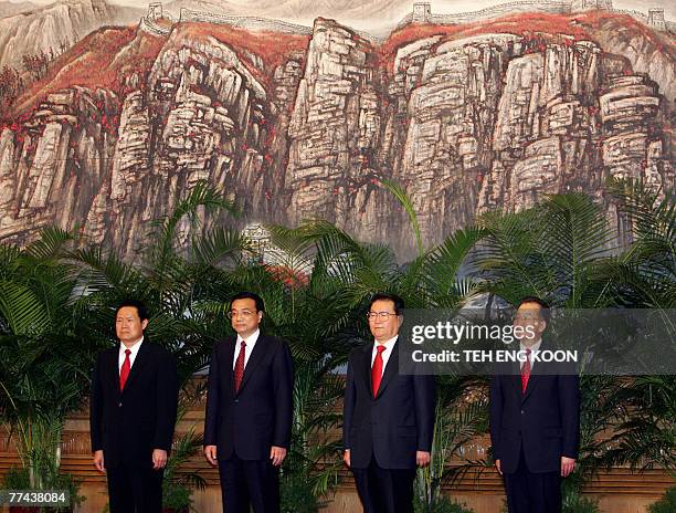 Four of the nine in the new leadership team Zhou Yongkang, Li Keqing, Li Changchun and Premier Wen Jiabao pose during a press conference at the Great...