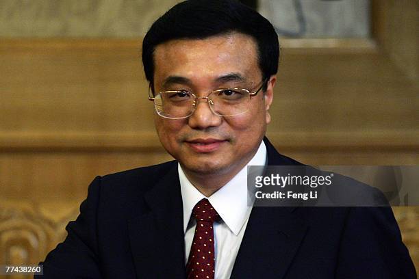 Li Keqiang, one of the new nine-seat Politburo Standing Committee, greets the media at the Great Hall of the People on October 22, 2007 in Beijing....
