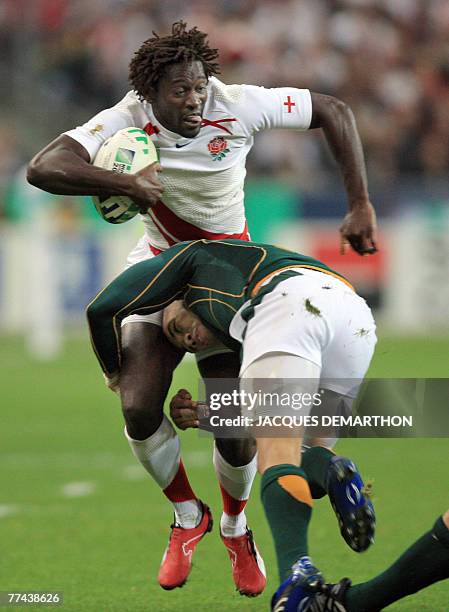 England's winger Paul Sackey is tackled by South Africa's winger Bryan Habana during the rugby union World Cup final match England vs. South Africa,...