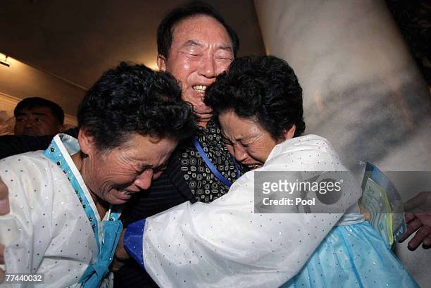 South Korean Kim Yu-Kwon cries with his North Korean sisters during their final meeting of the three-day temporary family reunion at Mount Kumgang on...