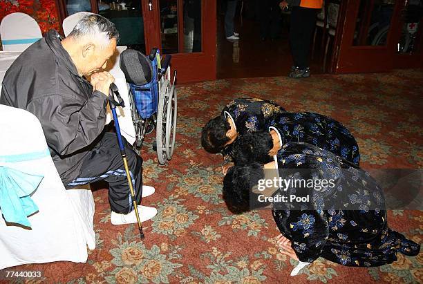 North Korean women bow to their South Korean brother and father Ryu Hyung-Ryul during their final meeting at the three-day temporary family reunion...