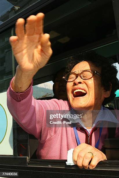South Korean Ahn Geum-Chul on a bus, cries as she calls out to her North Korean daughter after their three-day temporary family reunion at Mount...