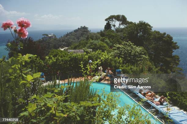 Guests by the pool at Klaus Pudel's villa, the Casa Montefino, overlooking Portofino harbour, Portofino, Italy, August 1977.
