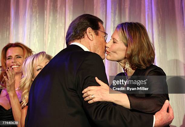 Honoree Sir Roger Moore kisses Bond girl Maud Adams during the Thalians 52nd Anniversary Gala honoring Sir Roger Moore to raise funds for the...