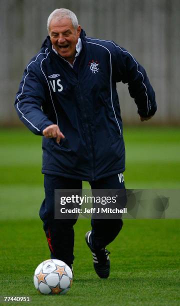 Walter Smith coach of Rangers chases a ball during a team training session at Murray Park ahead of their Champions League, Group E match against...