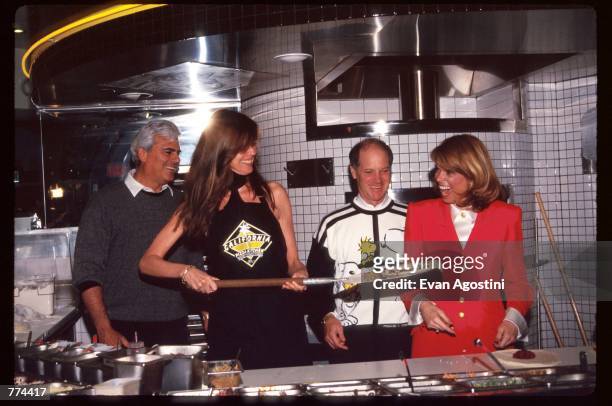 New York Lieutenant Governor Betsy McCaughey and model Carol Alt stand in the kitchen at the grand opening of California Pizza Kitchen near...