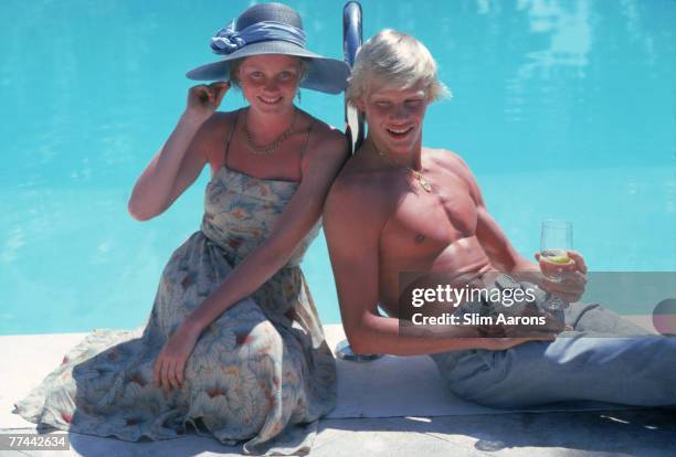 Aimee Louise and John Horsting, brother and sister from Illinois, sitting by the pool on Windermere Island, in the Bahamas, April 1980.