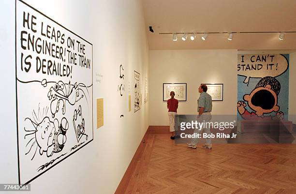 Invited guests examine artwork inside the Charles M. Schulz Museum and Research Center in Santa Rosa, Calif. Prior to the grand opening on Saturday,...