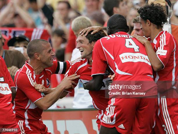 Chicago Fire's Chris Armas and Bakary Soumare celebrate with John Thorrington after Thorrington scored the winning goal during the second half of an...