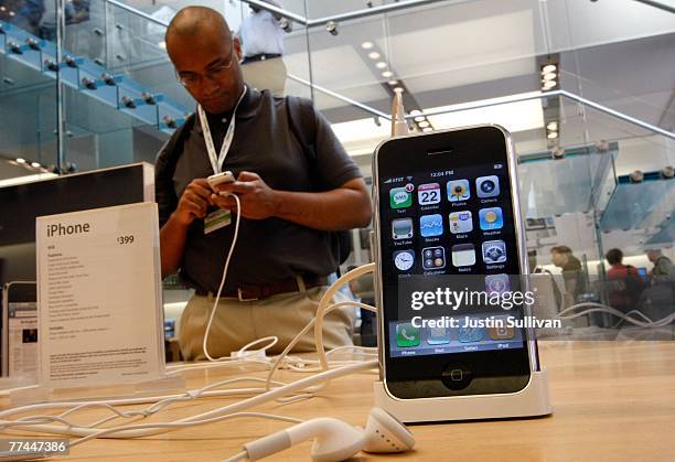 Customer at an Apple Store inspects the Apple iPhone October 22, 2007 in San Francisco, California. Apple stock surged $3.94 to close at a record...