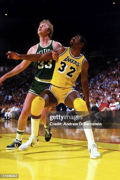 Magic Johnson of the Los Angeles Lakers battles for position against Larry Bird of the Boston Celtics during a game in 1984 at The Great Western...