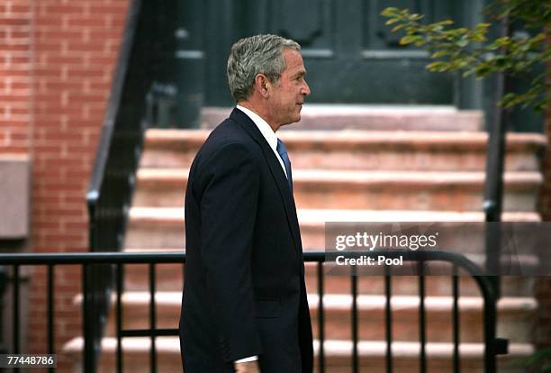 President George W. Bush surrounded by Secret Service agents walks by Lafayette Park to attend a Republican Governors Association reception at the...