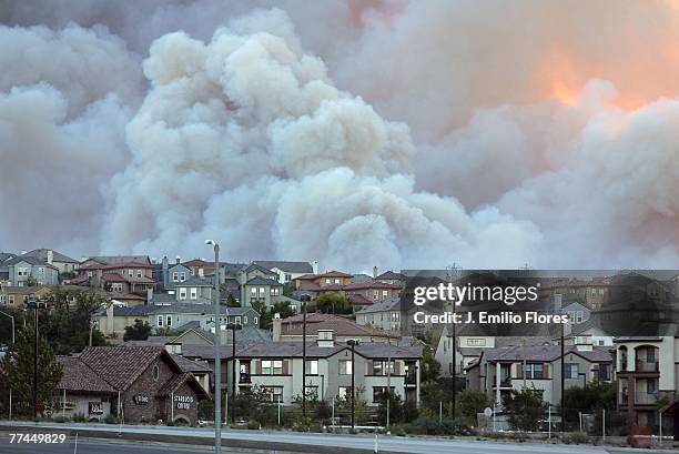 Smoke billows to the sky above where fires are spreading near houses October 22, 2007 in Stevenson Ranch, California. Fires today began near the...