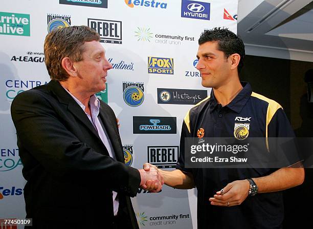 Central Coast Mariners Executive Chairman Lyall Gorman shakes hands with John Aloisi at a press conference announcing Aloisi's signing for the...