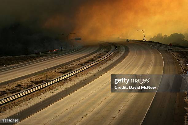 Interstate 15 near Reche Road is shut down as the Rice Fire jumps the freeway and destroys at least 100 homes on October 22, 2007 near Fallbrook,...