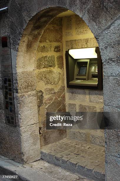 Detail of an ATM cash dispenser inside a stone wall August, 2007 in Villefranche de Conflent, France.