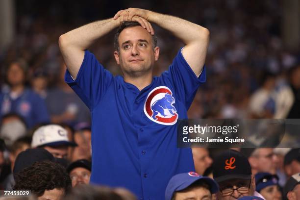 Fan of the Chicago Cubs looks on dejected against the Arizona Diamondbacks during Game Three of the National League Divisional Series at Wrigley...