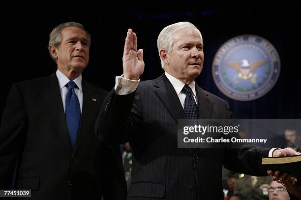 Robert Gates, left, is sworn in as the new US Defense Secretary by US Vice President Dick Cheney as US President George W. Bush looks on at the...